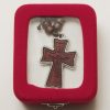 Wooden cross with metal encasement and leather cord