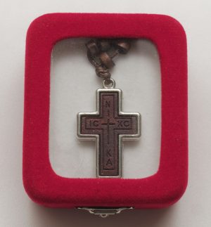 Wooden cross with metal encasement and metal chain